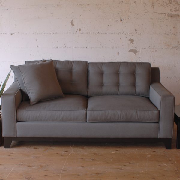 grey loveseat sofa and and black side table