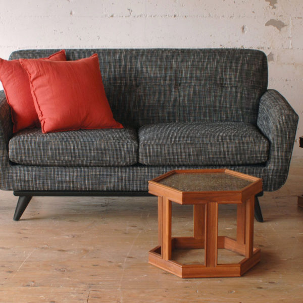 grey loveseat sofa in a living room with furniture and decor