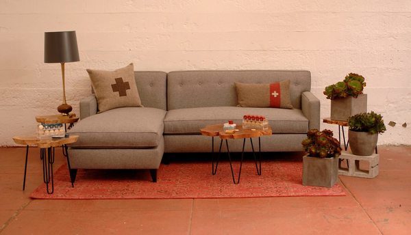 grey sofa in a living room with furniture and decor