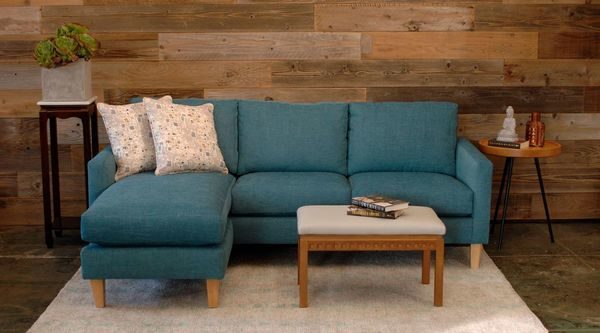 teal sofa in a living room with furniture and decor