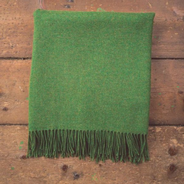 green blanket with tassels