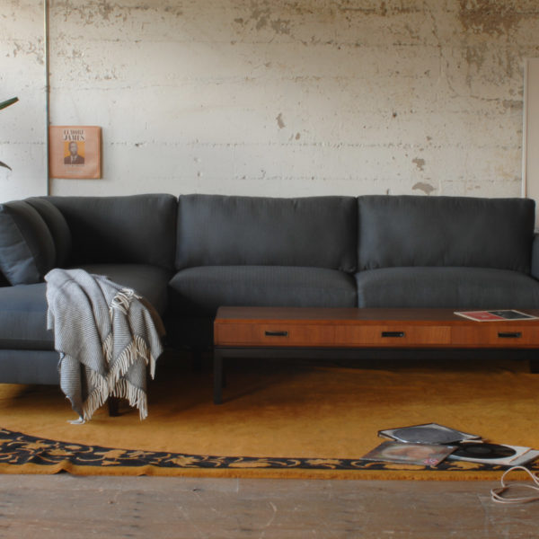 grey sofa in a living room with furniture and decor