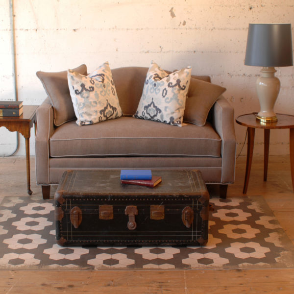 small grey sofa with white trim in a living room with furniture