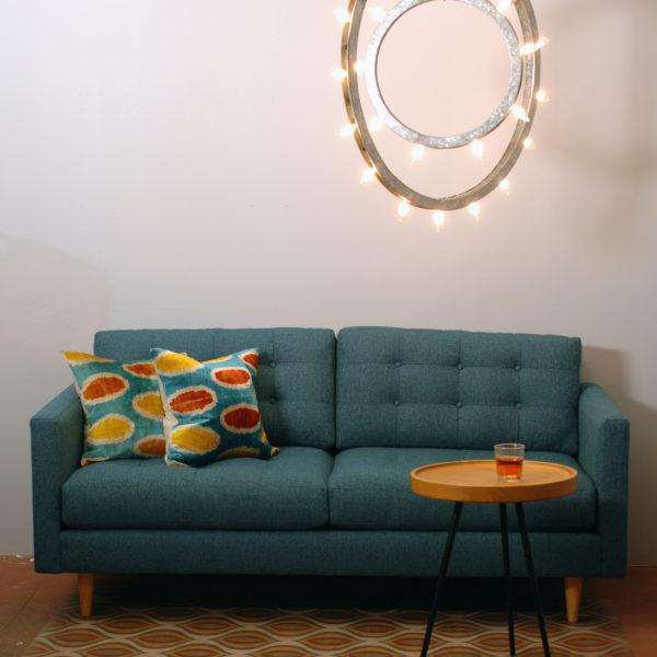 teal sofa and two decorative pillows