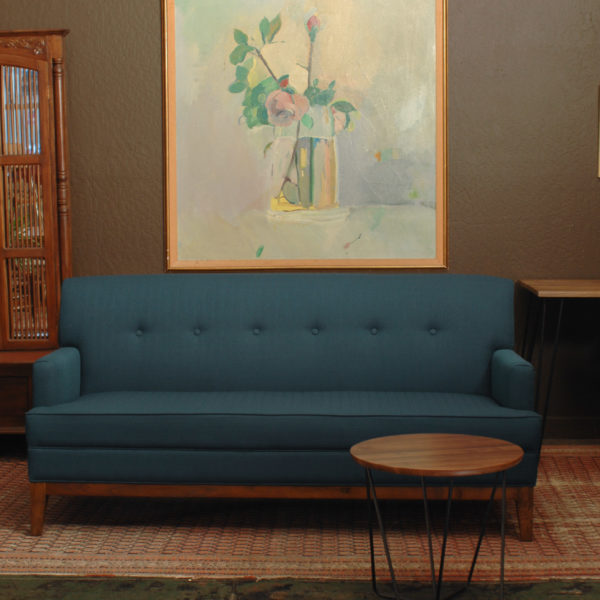 Blue sofa in living room with furniture and decor