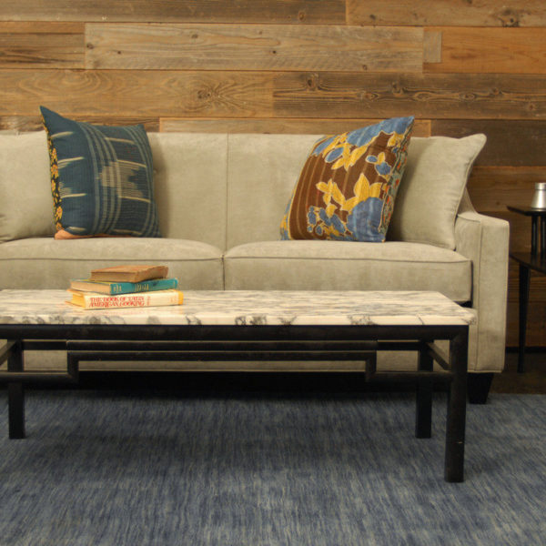 cream colored velvet sofa in a living room with furniture and decor