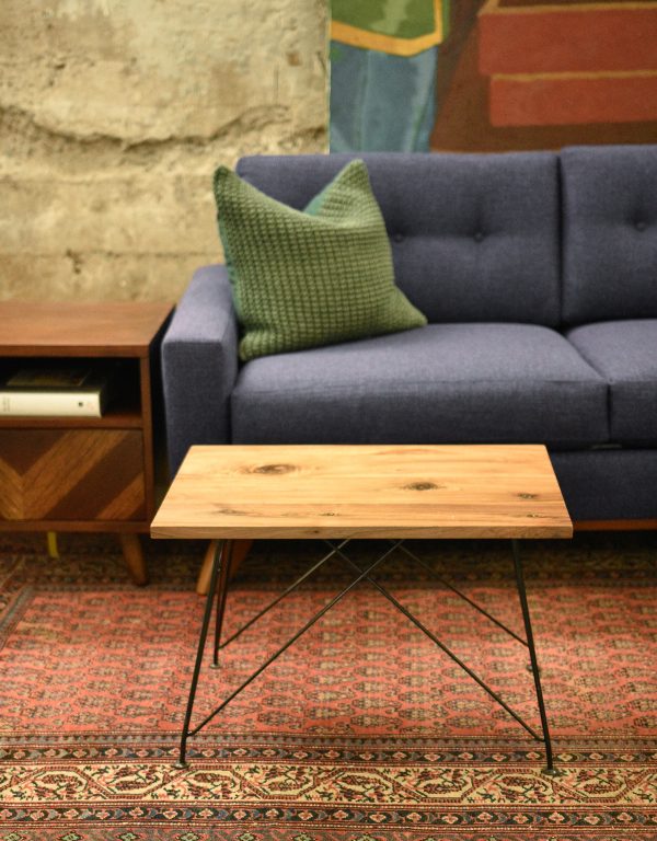 wood coffee table in a living room with furniture and decor