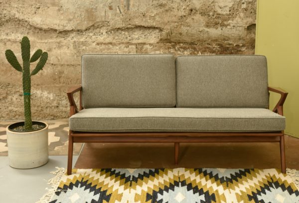 grey sofa with wood base in a living room