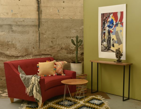 large curved red chair in a living room with decor