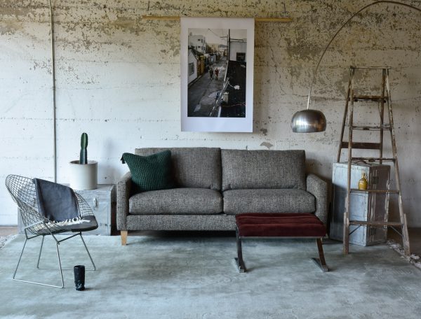 grey sofa in a living room with furniture and decor