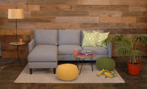 Grey sofa in living room with decor and plants