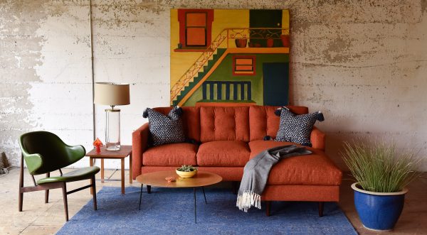 orange sofa in a living room with furniture and decor