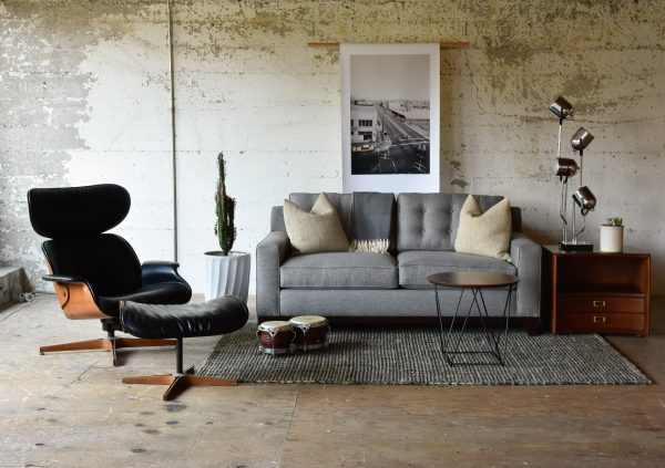 grey sofa in a living room with furniture and decor