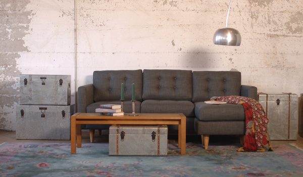 grey sofa in a living room with furniture and decor