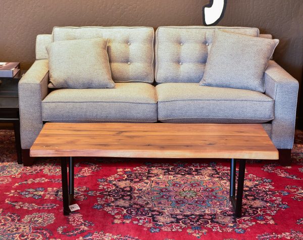 wood and steel coffee table on a red rug