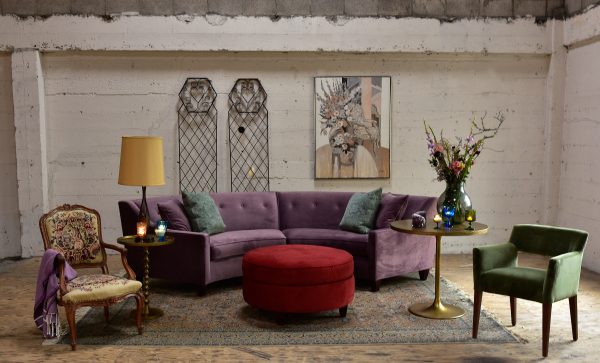purple velvet sofa in a living room with furniture and decor