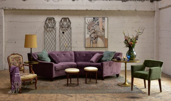 purple velvet sofa in a living room with furniture and decor