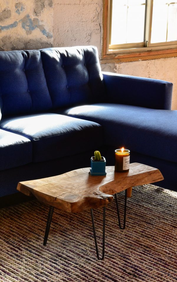 Blue sofa in living room with furniture and decor