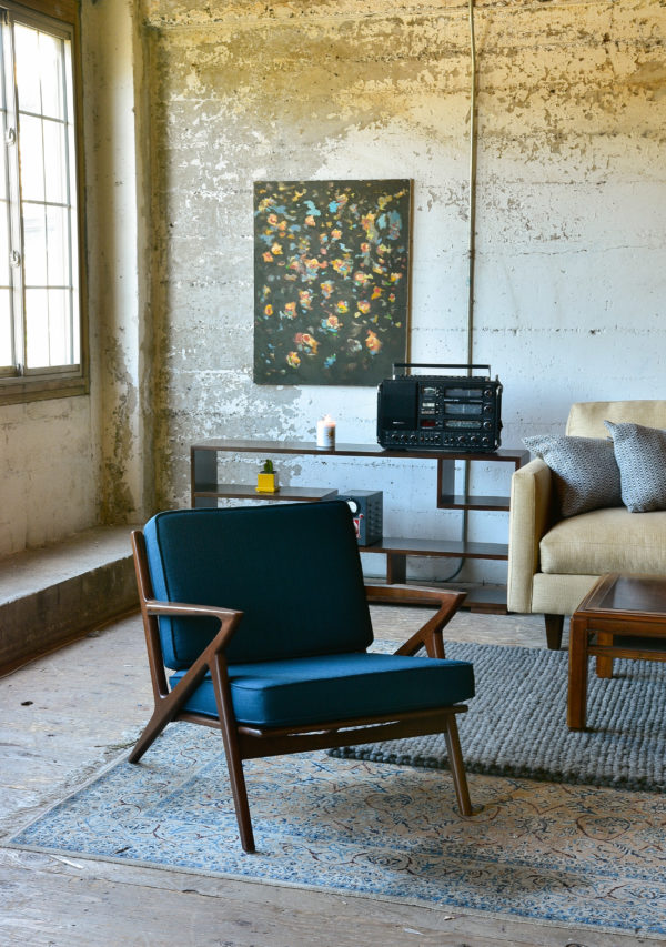 Blue accent chair in living room with decor