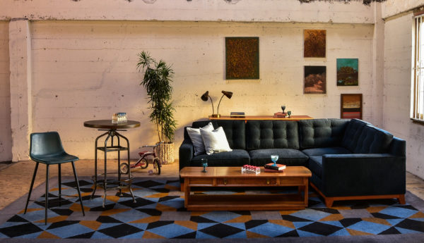 Navy blue sofa in a living room with decor and plants