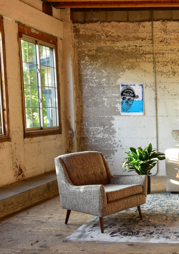 Grey arm chair in living room with decor