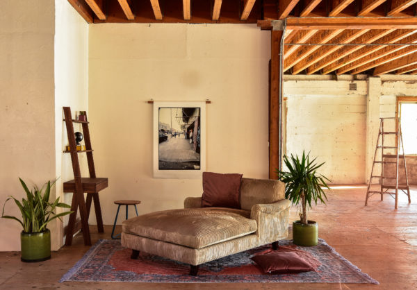 Grey velvet lounge chair in living room with decor