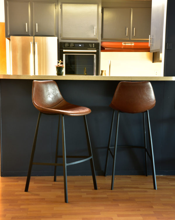 brown leather bar stools at kitchen counter