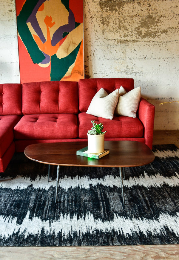 Red sofa in living room with decor