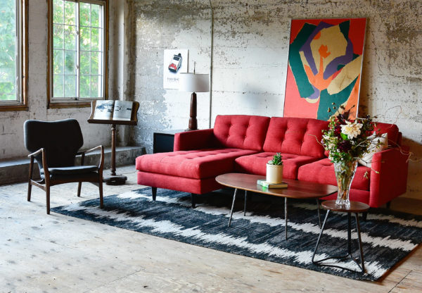 Red sofa in living room with decor