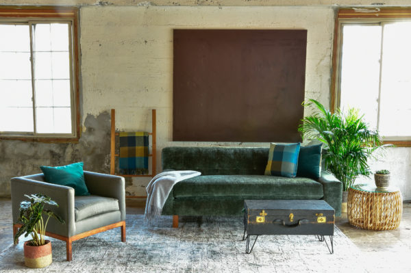 Green velvet sofa and decor in living room