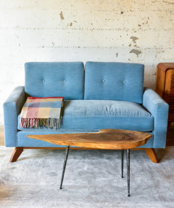 Blue velvet sofa in living room with decor