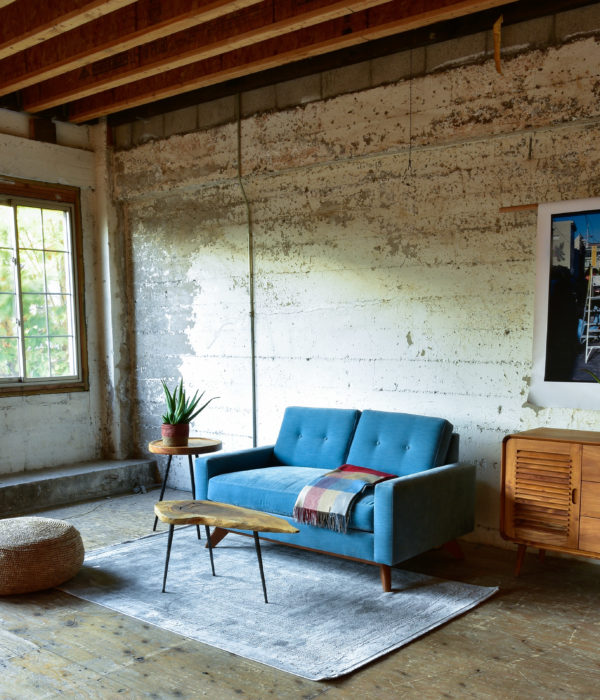 Blue velvet sofa in living room with decor