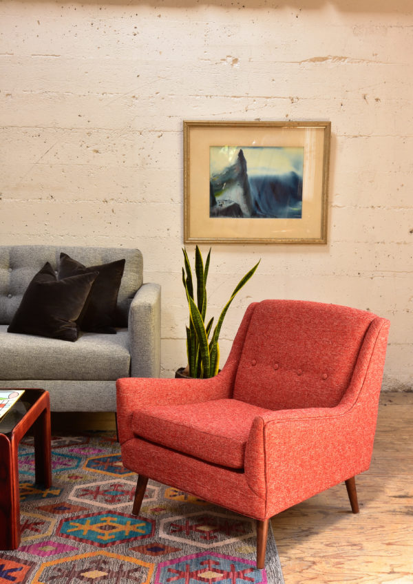 Red armchair in living room with decor